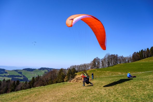 Hang glider start A hang glider takes off from a wooden ramp on a mountain